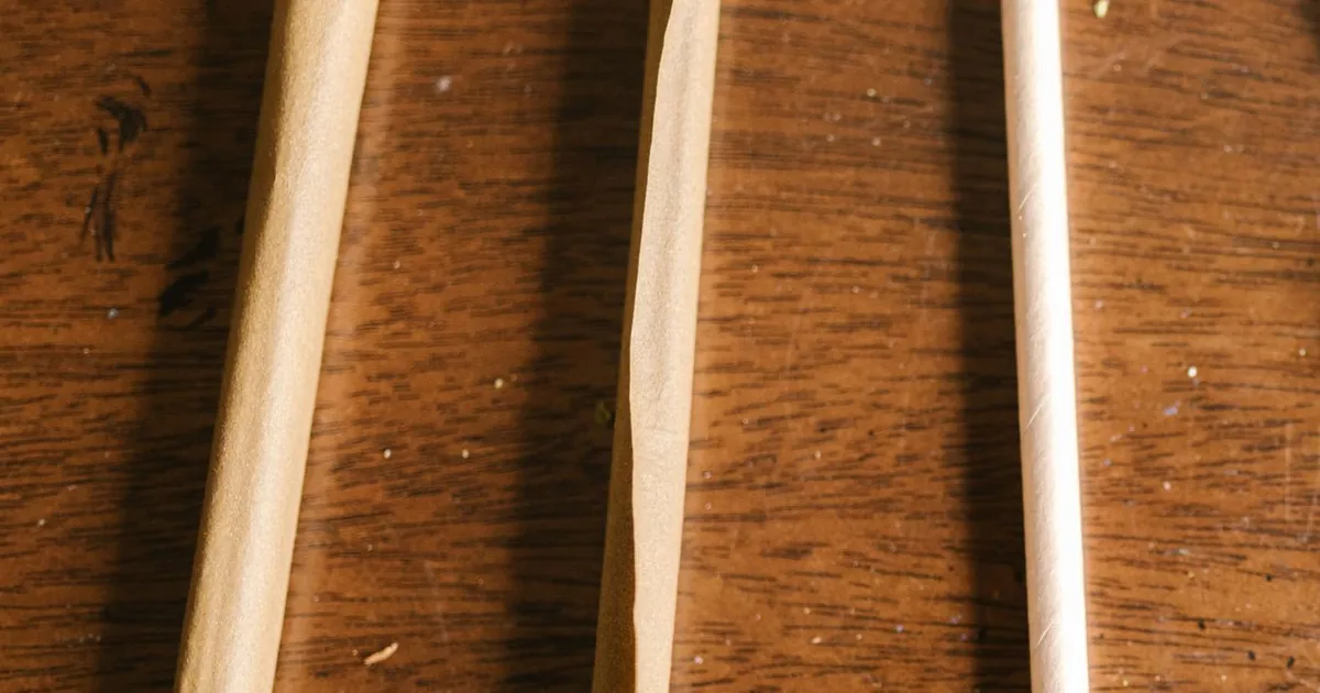 Three rolls in brown unbleached and white paper on a wooden table