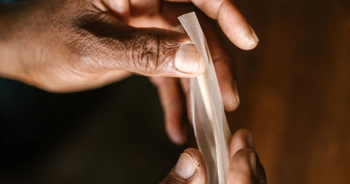 Hands rolling a sheet of paper into a cone